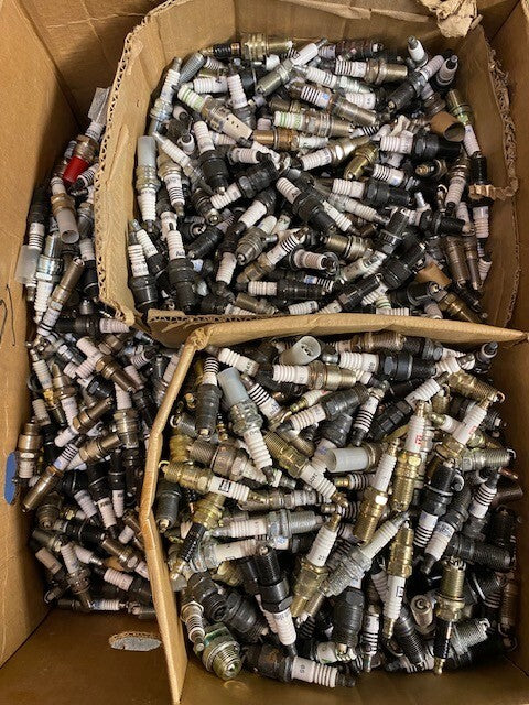 135lb Box of a Variety of Autolite, Champion, Bosch, Mighty, Denso Spark Plugs